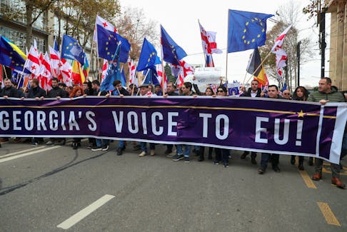 People take part in a procession in support of Georgia's membership in the European Union in Tbilisi, Georgia, December 9, 2023.