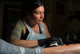 Becky Matheson from Wanderlust Tattoo Halifax works on client Sasha Banks's leg on Tuesday, Dec. 12, 2023.
Ryan Taplin - The Chronicle Herald