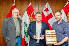 P.E.I. Premier Dennis King, centre, receives Transport Action Atlantic’s John Pearce Award from TAA president Tim Hayman, right, and past president Ted Bartlett. - Contributed