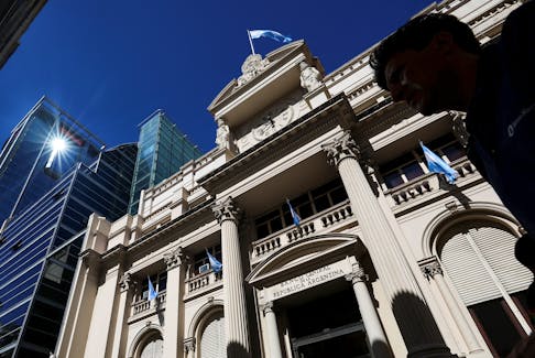 A man walks past the facade of Argentina's Central Bank, one day after the inauguration of Argentina's President Javier Milei and his Vice President Victoria Villarruel, in Buenos Aires, Argentina, December 11, 2023.