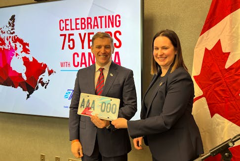 Digital Government and Service NL Minister Sarah Stoodley presents Premier Andrew Furey with the province’s first commemorative licence plate marking 75 years of Confederation. Juanita Mercer • SaltWire