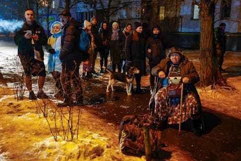 Local residents gather outside of their apartment building damaged during a Russian missile strike, amid Russia's attack on Ukraine, in Kyiv, Ukraine December 13, 2023.