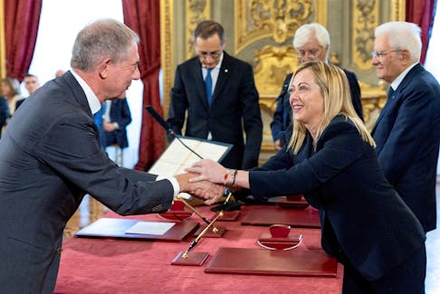 Italy's new Minister for Industry and Made in Italy (formerly Economic Development) Adolfo Urso shakes hands with Italy's Prime Minister Giorgia Meloni during the swearing-in ceremony at the Quirinale Presidential Palace, in Rome, Italy October 22, 2022. Italian Presidency/Handout via