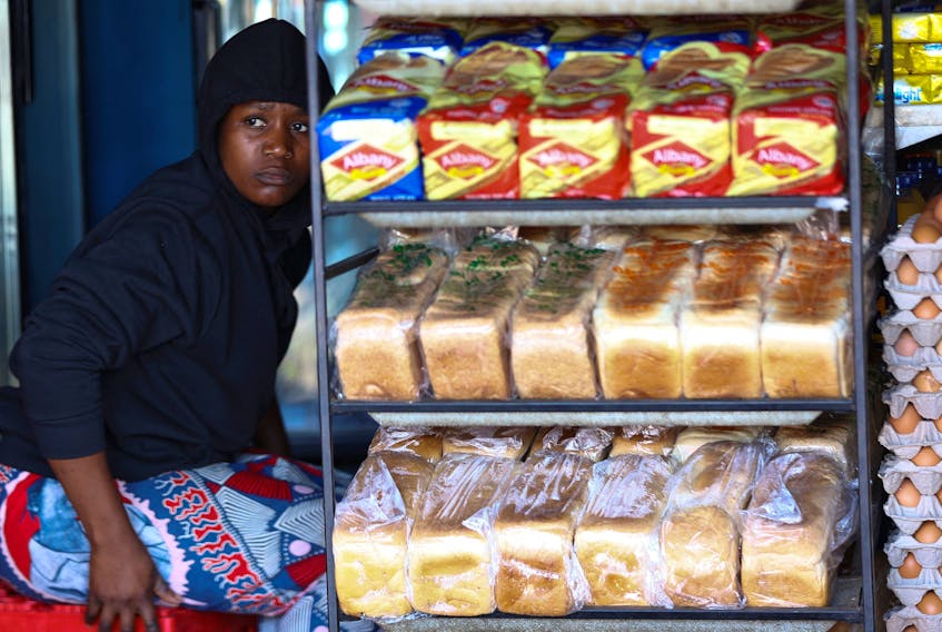 A worker looks on next to loafs of bread at a spaza shop in Thembisa, on the East Rand, in South Africa, August 2, 2023.