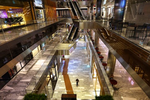 A person walks through a nearly empty area of retail shops inside The Shops & Restaurants at Hudson Yards in Manhattan in New York City, New York, U.S., April 17, 2023.