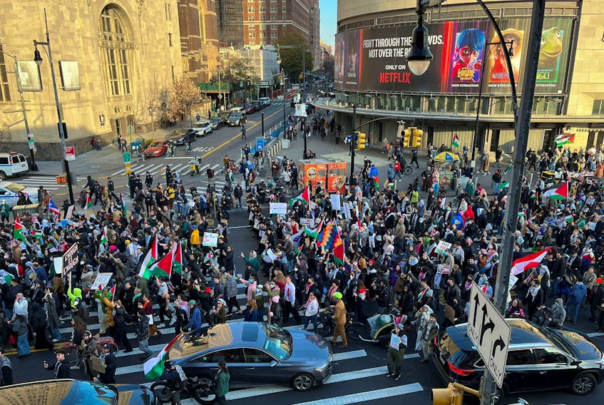 People march down Flatbush Avenue in the New York City borough of Brooklyn, during a pro-Palestinian demonstration, amid the ongoing conflict between Israel and Palestinian Islamist group Hamas, in New York, U.S., December 9, 2023.