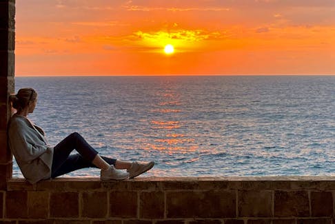Jenny Johnson watching a sunset in Lebanon.