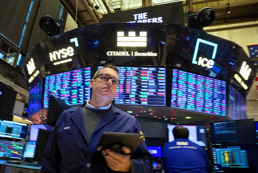 Traders work on the floor at the New York Stock Exchange (NYSE) in New York City, U.S., December 13, 2023.