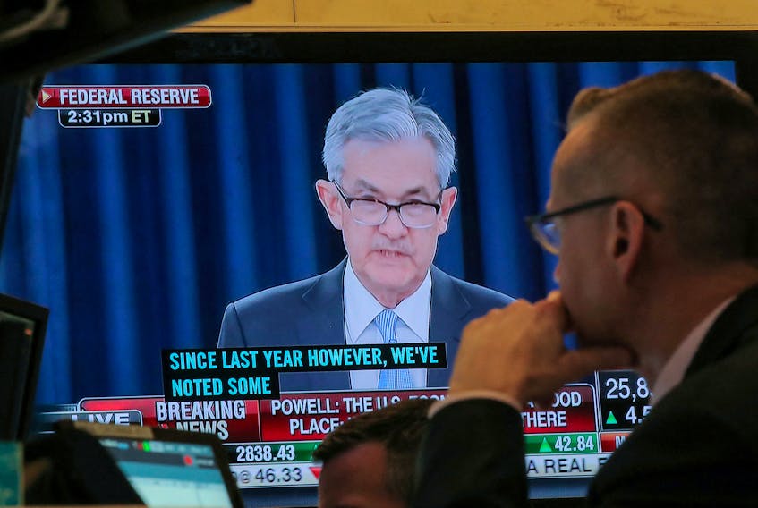 A trader watches U.S. Federal Reserve Chairman Jerome Powell on a screen during a news conference following the two-day Federal Open Market Committee (FOMC) policy meeting, on the floor at the New York Stock Exchange (NYSE) in New York, U.S., March 20, 2019.