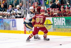 The Acadie-Bathurst Titan’s Dawson Sharkey, 81, of Souris, P.E.I., and the Charlottetown Islanders’ Simon Duguay, 24, follow the puck during a Quebec Maritimes Junior Hockey League game in Bathurst, N.B., on Dec. 18. Sharkey was called up from the Charlottetown Bulk Carriers Knights of the New Brunswick/P.E.I. Major Under-18 Hockey League for the game. Acadie-Bathurst Titan • Special to The Guardian