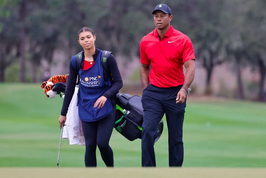 Dec 17, 2023; Orlando, Florida, USA;  Tiger Woods walks onto the 18th green with his daughter Sam Woods during the PNC Championship at The Ritz-Carlton Golf Club. Mandatory Credit: Reinhold Matay-USA TODAY Sports