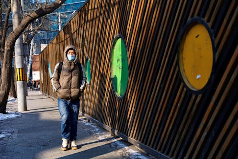 A person walks on a street in Beijing's Central Business District (CBD) on a cold winter day in Beijing, China December 18, 2023.