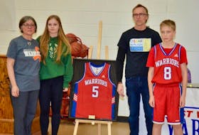 East Wiltshire Intermediate School retired Oscar Waugh’s No. 5 basketball jersey during a ceremony on Dec. 14. Members of Oscar’s family, from left, mother Catherine, sister Grace, father Trevor and brother Harry, unveiled the jersey before a P.E.I. School Athletic Association Intermediate AA Boys Basketball League game between East Wiltshire and Hernewood. Oscar, who played soccer and basketball at East Wiltshire, died in July 2023 after an 18-month battle with cancer.