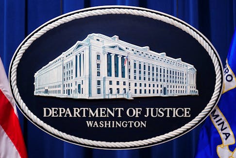 A U.S. Justice Department logo or seal showing Justice Department headquarters, known as "Main Justice," is seen behind the podium in the Department's headquarters briefing room before a news conference with the Attorney General in Washington, January 24, 2023. 