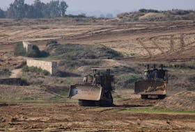 Israeli armoured Caterpillar D9 bulldozers manoeuvre near the border with Gaza , after a temporary truce between Israel and the Palestinian Islamist group Hamas expired, in Israel, December 1, 2023.