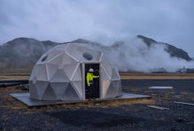 Silja Yraola, an employee of Icelandic startup Carbfix, enters the dome with injection well at its facility in Olfus, Iceland, November 21, 2023. Icelandic startup Carbfix is the world's first CO2 mineral storage operator, permanently sequestering CO2 by mixing it with water and injecting into basalt rock. At its facility in Olfus, on the southwestern coast of Iceland, CO2 piped in from the nearby power plant is being mixed with water drawn up from the ground and injected into the basalt rock below.