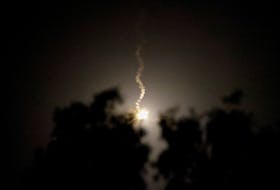 A flare lights up the night sky in Gaza, amid the ongoing conflict between Israel and the Palestinian Islamist group Hamas, as seen from southern Israel, December 2, 2023.