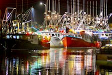 Lights and the colours of the fishing vessels are reflected in the water in the Pinkney's Point, Yarmouth County, harbour on the morning of Dec. 2 when the LFA 34 lobster season finally got underway with what is called Dumping Day. The six-month season had been slated to start Nov. 27 but weather kept the boats ashore for five days. TINA COMEAU