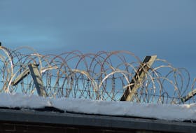 Rolls of razor and barbed wire sit on the wall near the entrance to Her Majesty's Penitentiary on Forest Road.

Photo by Keith Gosse/The Telegram