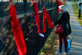 A woman looks at one of the scarves tied to the Halifax Public Gardens fence on Friday, Dec. 1, 2023. Hundreds of scarves were placed on the fence by the AIDS Coalition of Nova Scotia as part of their Red Scarf Project. Knitters and crocheters made over 300 scarves for the project and they all had tags attached with information about HIV testing and prevention.
Ryan Taplin - The Chronicle Herald