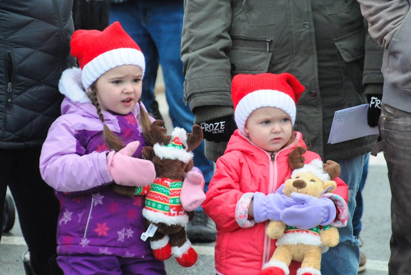hese two young girls clutch onto their Christmas teddy bears as they watch the 68th. annual Mount Pearl Lions Club Santa Claus parade on Saturday morning, December 2, 2023 making its way along the parade route on Ruth Avenue.
-Photo by Joe Gibbons/The Telegram