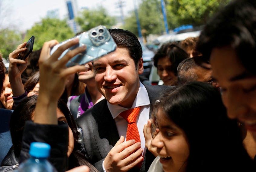 Governor of Nuevo Leon state Samuel Garcia poses for a picture with students as he arrives at an event of school equipment delivery at the Prepa Tec high school, in Monterrey, Mexico April 25, 2023.