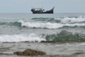 A wooden boat that carried Rohingya Muslims is seen off the coast in Sabang, Aceh province, Indonesia, November 22, 2023.