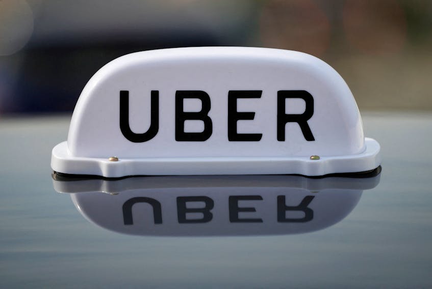 The Logo of taxi company Uber is seen on the roof of a private hire taxi in Liverpool, Britain, April 15, 2019.