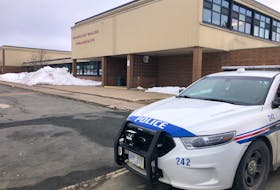 A police car parked outside Prince of Wales Collegiate on Wednesday, March 15. A fourth teen has been arrested and charged with attempted murder in relation to an attack on a student outside the high school's entrance on March 9. Joe Gibbons • The Telegram