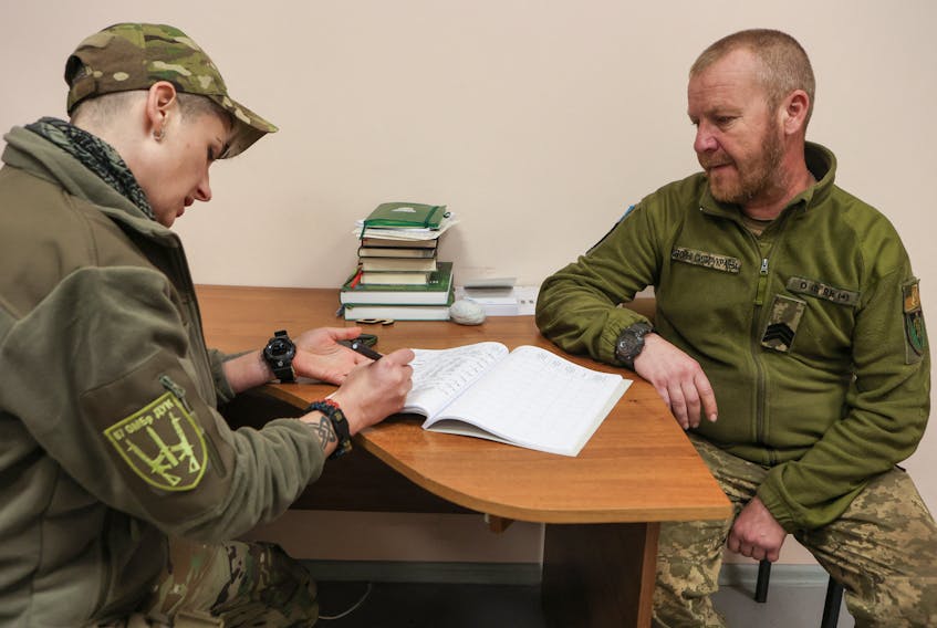 Dana Vynohradova, 39-year-old, deputy commander of the 67th Separate Mechanized Brigade 'Ukrainian Volunteers Corps' for moral and psychological support, speaks with brigade's serviceman with the call sign 'DJ' at a military medical centre, amid Russia's attack on Ukraine, in Donetsk region, Ukraine November 16, 2023.