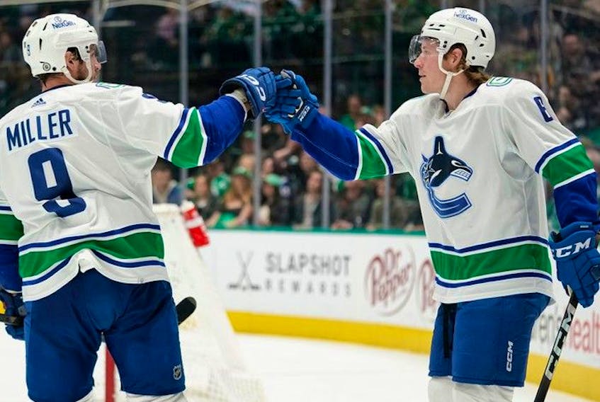  Brock Boeser gets a congrats from JT Miller after scoring his 24th goal of the season against the Dallas Stars.
