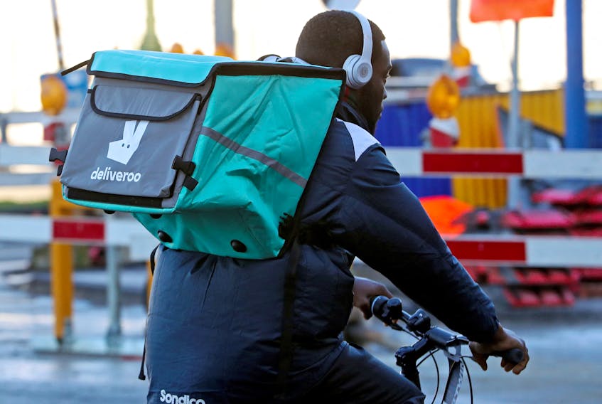 A courier for food delivery service Deliveroo rides a bike in central Brussels, Belgium January 16, 2020. Picture taken January 16, 2020.