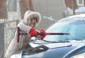 With the bone chilling temperatures on Saturday, February 4, 2023, combined with the high winds, extreme cold, frost bite warnings and wind chill factors, it thus played somewhat of a havoc for motorists and ice build-ups on the vehicle windows. Here on Harvey Road on Saturday morning, this lady motorists works on breaking the ice remnants from her Toyota car’s front windshield, amidst the wintry weather. Mild temperatures of 4*C though are forecast for today with rain showers and maybe a tiny bit of snow. -Photo by Joe Gibbons/The Telegram    NOTE: Today is for Monday, February 6th., 2023.