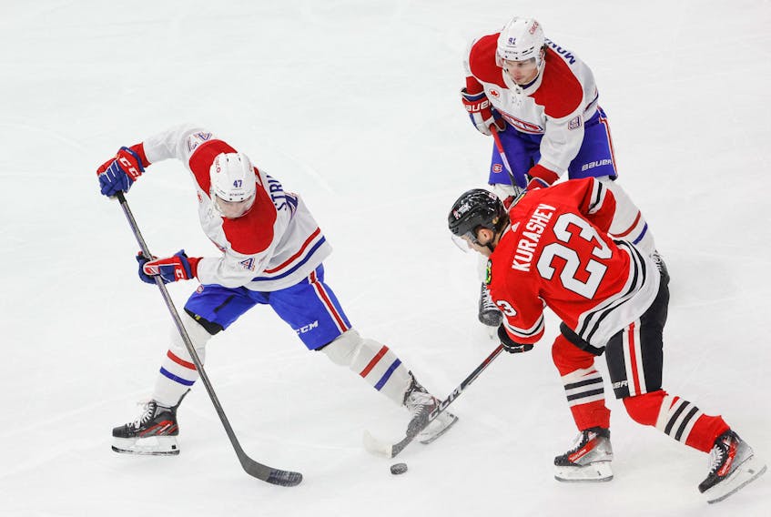 Dec 22, 2023; Chicago, Illinois, USA; Montreal Canadiens defenseman Jayden Struble (47) battles for the puck with Chicago Blackhawks center Philipp Kurashev (23) during the first period at United Center. Mandatory Credit: Kamil Krzaczynski-USA TODAY Sports