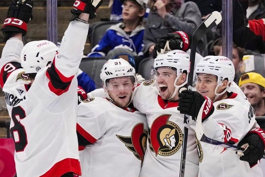 Senators' Drake Batherson (second from right) celebrates with teammates after scorign against the Maple Leafs on Wednesday.