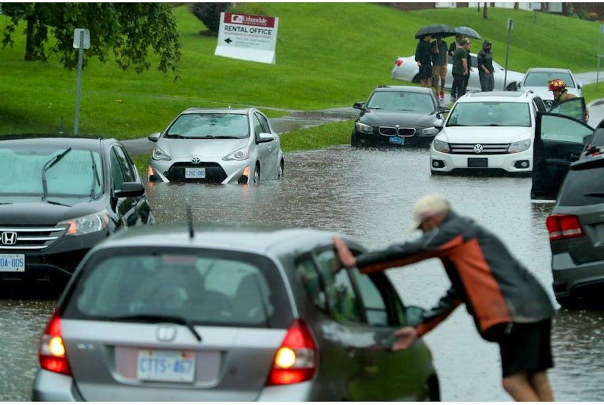  Cars got waterlogged, stuck and had to be abandoned along Halifax Drive in Ottawa on Aug. 10 as water rose up to the windshield on some before receding so people could retrieve their belongings.