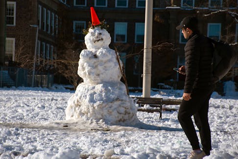 A student walks past a large, and somewhat terrifying, snowman on the Dalhousie campus on Friday, Dec. 8, 2023.
Ryan Taplin - The Chronicle Herald