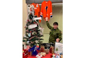 14 Wing Greenwood’s units, with community organizations and businesses, are preparing to deck the halls of the Greenwood Mall Dec. 9, as the wing’s Combined Charities campaign hosts the annual Festival of Trees. Cpl. April Watson shows off some of the items featured on the 2022 hourly prize draw tree.