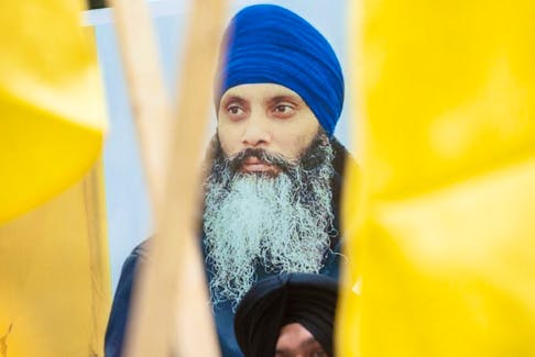 A photo of murdered Sikh independence leader Hardeep Singh Nijjar is carried during a protest outside the Indian consulate in Vancouver on June 24, 2023.