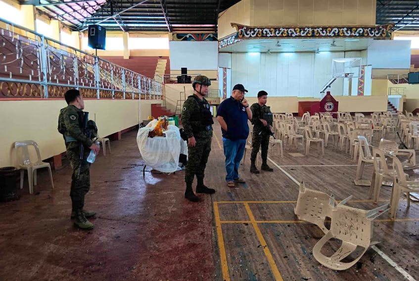 Lanao Del Sur Governor Mamintal Adiong Jr. looks on as law enforcement officers investigate the scene of an explosion that occurred during a Catholic Mass in a gymnasium at Mindanao State University in Marawi, Philippines, December 3, 2023. Lanao Del Sur Provincial Government/Handout via REUTERS