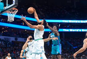 Dec 2, 2023; Charlotte, North Carolina, USA;  Minnesota Timberwolves center Karl-Anthony Towns (32) gets a rebound from Charlotte Hornets center Mark Williams (5) during the second half at the Spectrum Center. Mandatory Credit: Sam Sharpe-USA TODAY Sports