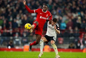 Soccer Football - Premier League - Liverpool v Fulham - Anfield, Liverpool, Britain - December 3, 2023 Fulham's Tom Cairney in action with Liverpool's Ibrahima Konate