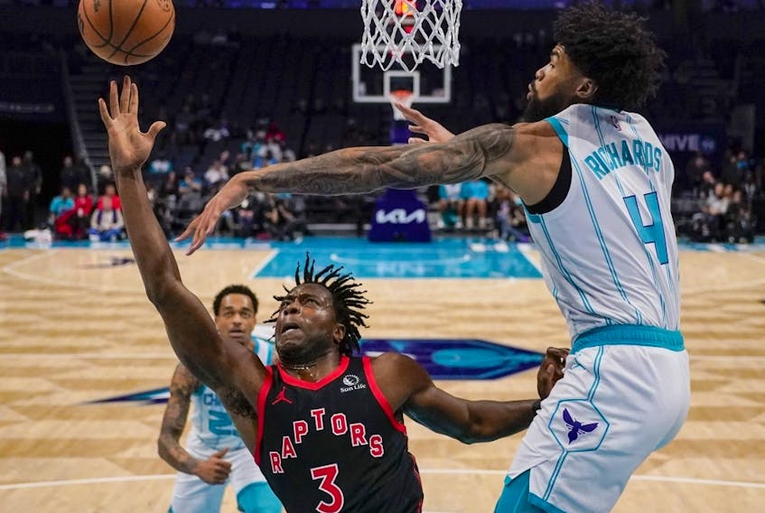 Hornets centre Nick Richards, right, blocks a shot by Raptors forward O.G. Anunoby during first half NBA action in Charlotte, N.C., Friday, Dec. 8, 2023.
