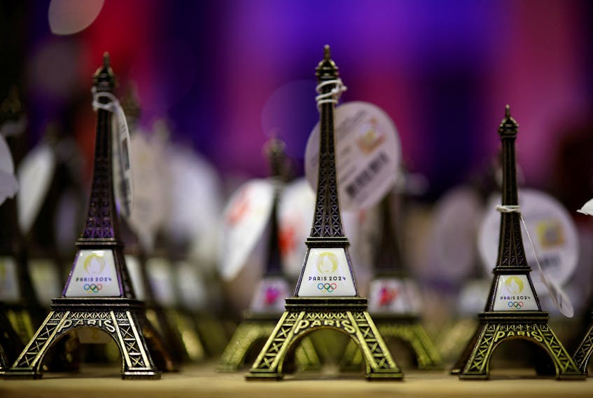 The logo of the Paris 2024 Olympic and Paralympic Games is seen on tiny Eiffel tower replicas inside an official Paris 2024 store at the Carrousel du Louvre in Paris, France, December 21, 2023.