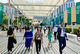 Delegates walk at the Dubai's Expo City during the United Nations Climate Change Conference (COP28) in Dubai, United Arab Emirates, December 4, 2023.