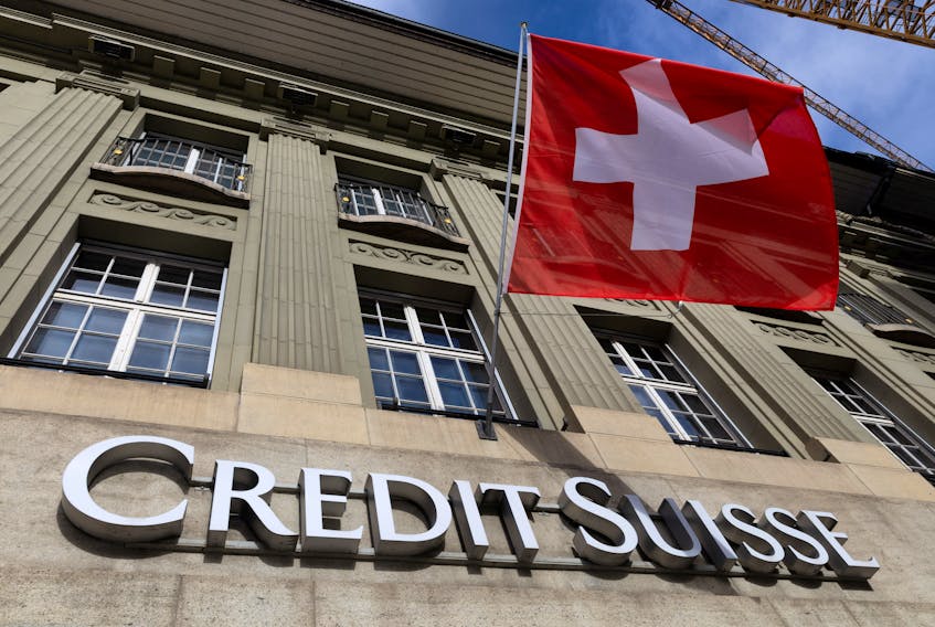 A Swiss flag is pictured above a logo of Swiss bank Credit Suisse in Bern, Switzerland, November 15, 2023. 