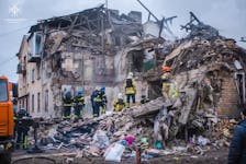 Rescues work at a site of a residential building heavily damaged by a Russian missile strike, amid Russia's attack on Ukraine, in the town of Novohrodivka, Donetsk region, Ukraine November 30, 2023. Press service of the State Emergency Service of Ukraine in Donetsk region/Handout via