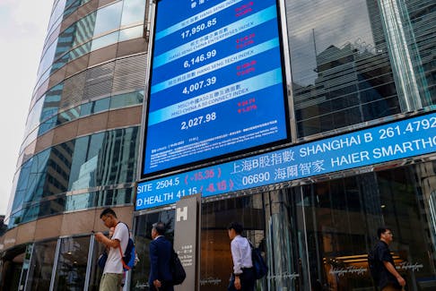 Screens showing the Hang Seng stock index and stock prices are seen outside Exchange Square, in Hong Kong, China, August 18, 2023.