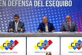 Venezuelan President Nicolas Maduro, Venezuelan National Assembly's President Jorge Rodriguez and Elvis Hidrobo Amoroso, head of Venezuela's National Electoral Council (CNE), attend an event at the National Electoral Council (CNE) after voters in a referendum rejected the International Court of Justice's (ICJ) jurisdiction over the country's territorial dispute with Guyana and backed the creation of a new state in the potential oil-rich Esequibo, in Caracas, Venezuela, December 4, 2023.