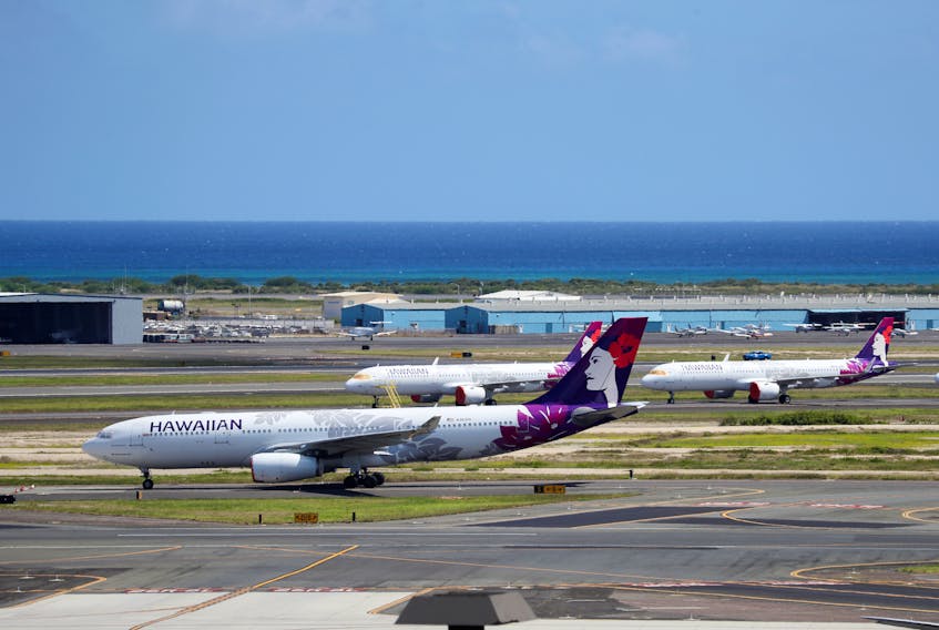 Hawaiian Airlines airplanes sit idle on the runway at the Daniel K. Inouye International Airport due to the business downturn caused by the coronavirus disease (COVID-19) in Honolulu, Hawaii, U.S. April 28, 2020. Picture taken April 28, 2020.